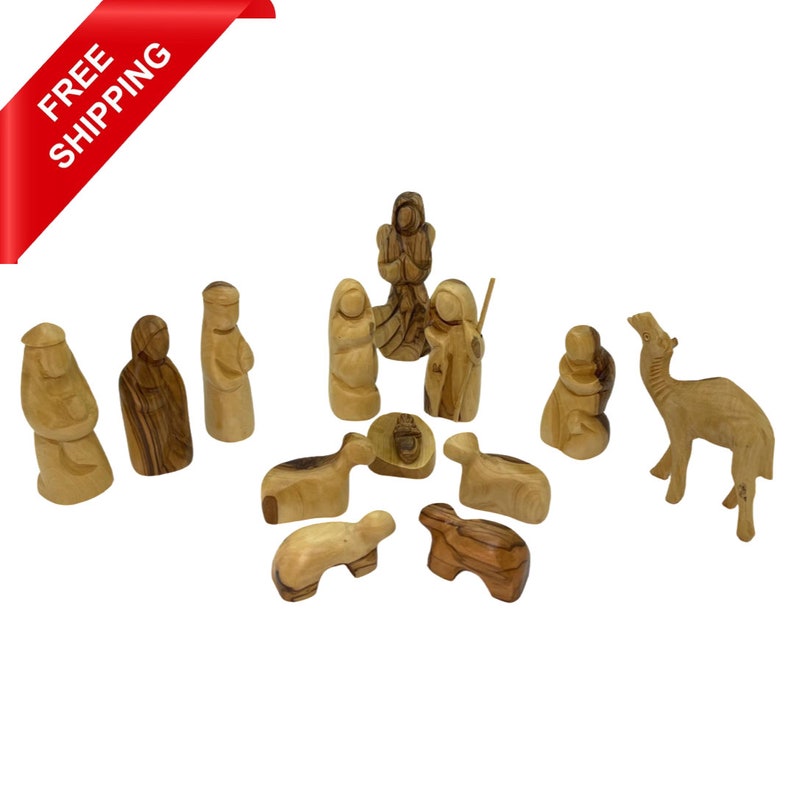 May include: A wooden nativity scene set with 12 hand-carved figures, including Mary, Joseph, baby Jesus, a camel, a shepherd, and sheep. The figures are made of olive wood and are painted in natural wood tones.