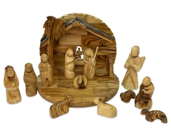May include: A hand-carved olive wood nativity scene set with a stable, figures of Mary, Joseph, the baby Jesus, a shepherd, an angel, and three wise men. The set also includes a palm tree, a donkey, a sheep, and a star.