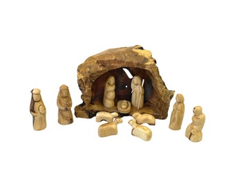 May include: A hand-carved olive wood nativity scene set with a manger, Mary, Joseph, baby Jesus, three wise men, and sheep. The figures are all carved in a simple, rustic style.