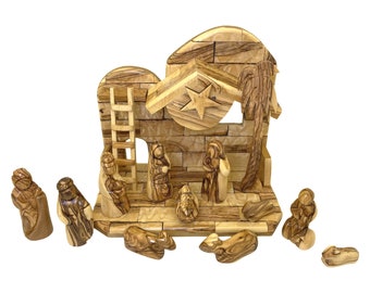 May include: A wooden nativity scene with a stable, a star, and figures of Mary, Joseph, and the baby Jesus. The figures are carved from olive wood and have a natural wood finish.