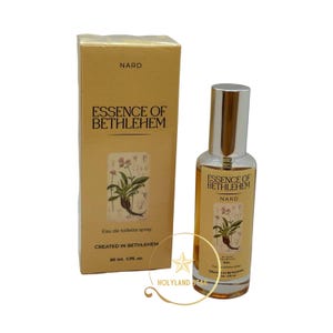 May include: A yellow and brown bottle of Nard Essence of Bethlehem Eau de Toilette spray. The bottle is 50 ml or 1.7 fl oz. The bottle has a label with a botanical illustration of a plant.