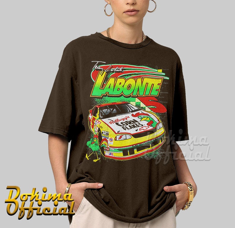 May include: A brown t-shirt with a vintage-style graphic of a race car with the text "Tim Labonte" and "Kellogg's Corn Flakes" on it.