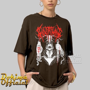 May include: A brown t-shirt with a white and red graphic print of a woman with a knife and the text "GHOST BATH" in red.
