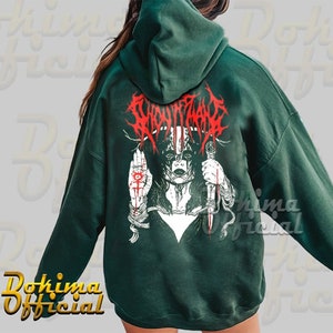 May include: A dark green hooded sweatshirt with a graphic print of a woman with a knife and the text "SLAUGHTER" in red.