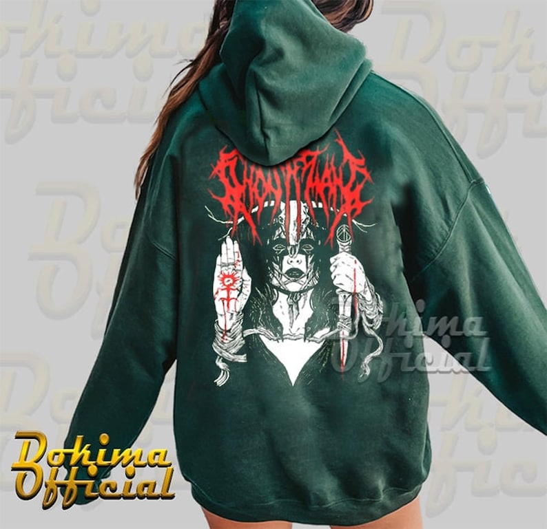 May include: A dark green hooded sweatshirt with a graphic print of a woman with a knife and the text "SLAUGHTER" in red.