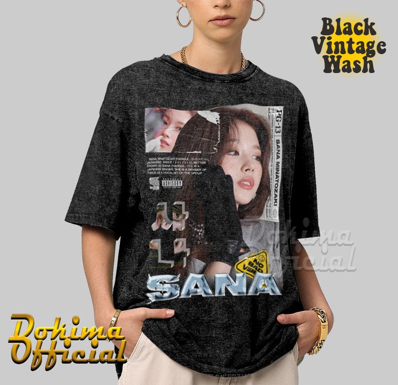 K&ouml;nnte beinhalten: Ein schwarzes Vintage-T-Shirt mit Wasch-Effekt und einem Grafikdruck mit dem Gesicht einer Frau und dem Text "SANA" in einer verwaschenen Schriftart. Die Grafik enth&auml;lt auch den Text "PG-13 SANA MINATOZAKI" und einen "BAD VIBES" Aufkleber.
