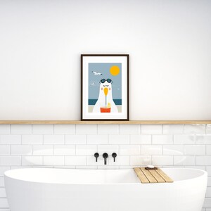 May include: A framed illustration of a cartoon seagull wearing sunglasses and drinking a beverage with a straw. The seagull is sitting on a beach with a blue ocean and a yellow sun in the background.