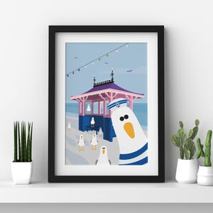 May include: A colorful illustration of a seagull wearing a sailor hat and standing in front of a pink and blue beach hut. Other seagulls are in the background.