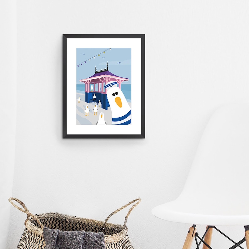 May include: A colorful illustration of a seagull wearing a sailor hat and standing in front of a pink and blue beach hut. The seagull is looking directly at the viewer. There are other seagulls in the background.