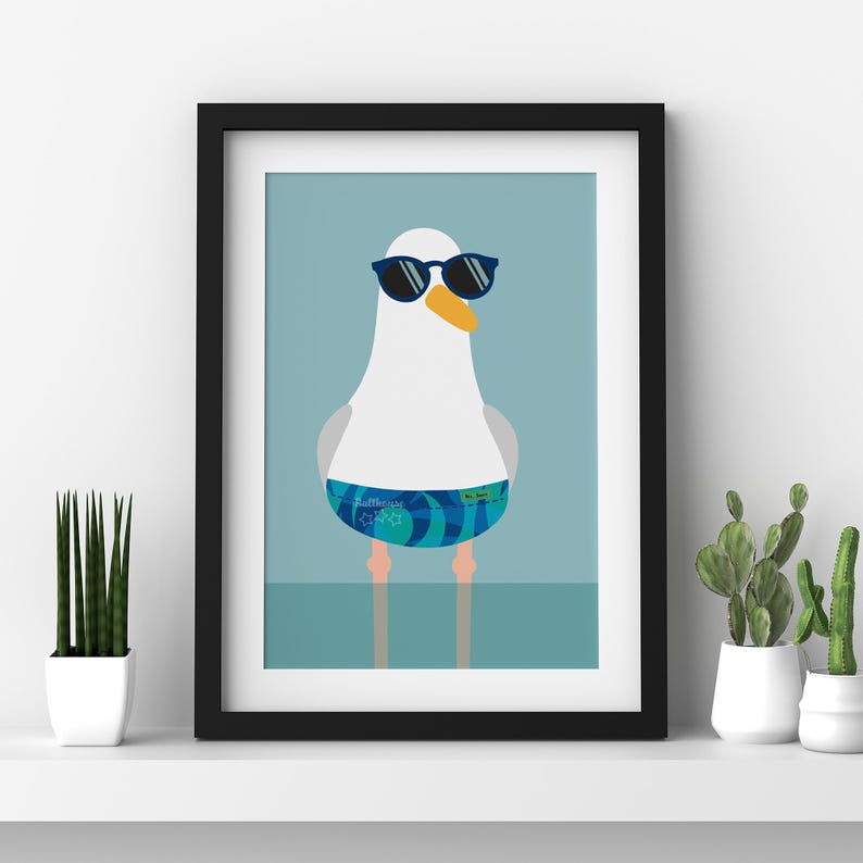 May include: Framed art print of a cartoon seagull wearing sunglasses and blue swim shorts. The seagull has a white body, grey wings, and an orange beak. The background is a light blue colour.
