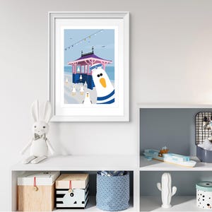 May include: A colorful illustration of a seagull wearing a sailor hat, standing in front of a pink and blue beach hut with a blue roof. The seagull is looking at the viewer. There are other seagulls in the background.