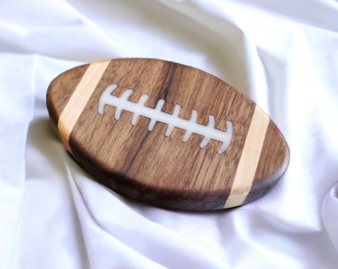 Bottle opener football shaped.  Can be customized for your favorite team.  Makes a great gift.  Made from solid Walnut.