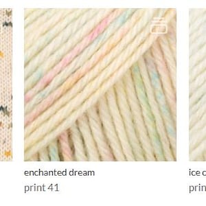 May include: Three skeins of yarn displayed side-by-side. The first is cream with multicolored specks labeled sunny memories long print 40. The second is cream with pastel stripes labeled enchanted dream print 41. The third is cream with blue specks labeled ice crystals print 42.