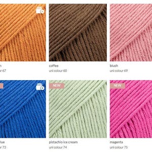 May include: A collection of six skeins of yarn in various colors, including pumpkin, coffee, blush, cobalt blue, pistachio ice cream, and magenta. Each skein is labeled with its color name and uni color number. The yarn is displayed in a close-up shot, highlighting the texture and color variations.