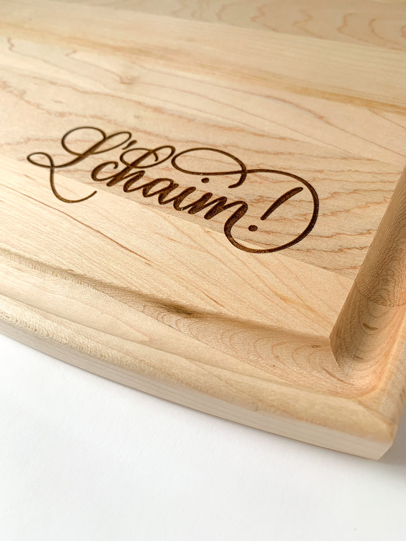 L'chaim custom engraved hardwood cutting board | Hanukkah decorations - a blog by Leah E. Moss Designs