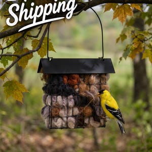 May include: A black metal bird feeder with a roof, filled with a mix of natural fibers. A yellow bird with black wings perches on the feeder. The text "Free Shipping" is in the upper left corner.