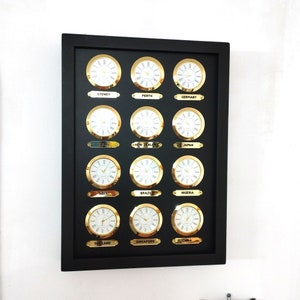 May include: A black framed wall clock with gold accents displays the time in 12 different cities around the world. The cities are Sydney, Perth, Germany, Israel, New Zealand, Japan, India, Brazil, Nigeria, Thailand, Singapore, and China.