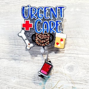 May include: A silver glitter badge reel with a blue and white "Urgent Care" sign, a red cross, a bone, a leopard print face mask, a pill bottle, and a red and black syringe charm.