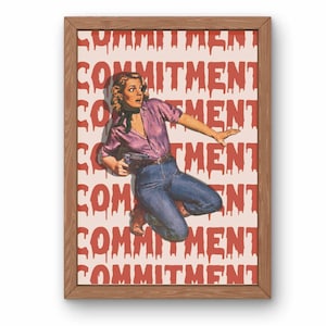 May include: A framed print of a woman in a purple shirt and blue jeans, jumping in front of a white background with the word "COMMITMENT" repeated in red dripping letters.