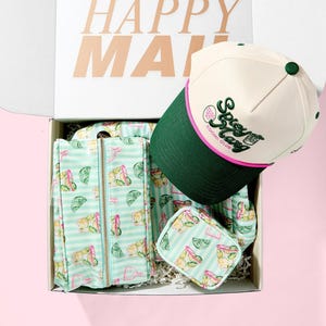 May include: A gift box with the words "HAPPY MAIL" printed on the inside lid. The box contains a white and green baseball cap with "Spicy Marg Social Club" text, a matching zip-up jacket, and a small pouch, all with a margarita and lime pattern.