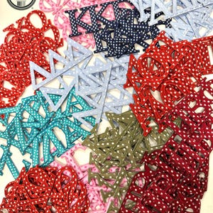 May include: A collection of Greek letter patches in various colors including red, pink, navy blue, light blue, teal, and olive green. Each patch features a white polka dot pattern. A circular black and white logo in the corner reads Affinity Licensed Product.