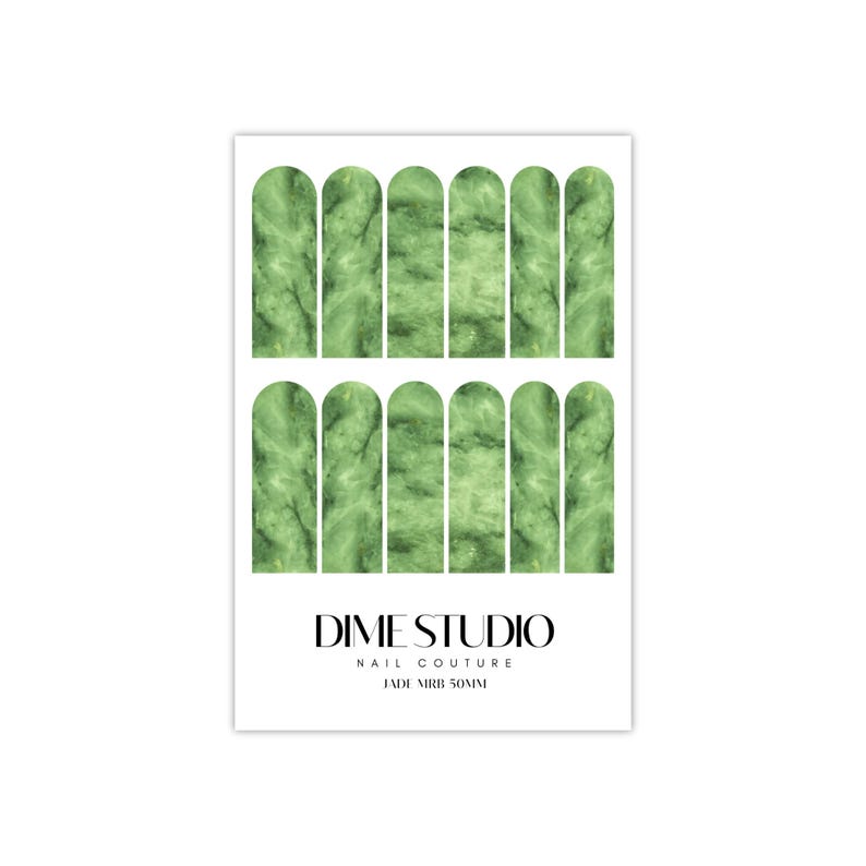 May include: Green marble nail wraps with a rounded shape. The nail wraps are arranged in two rows of six. The text "DIME STUDIO NAIL COUTURE JADE MIRB 50MM" is printed below the nail wraps.