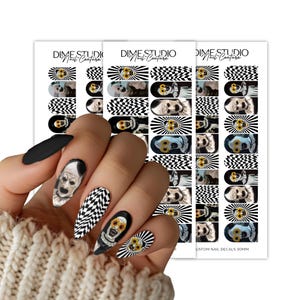 May include: Three sheets of Dime Studio Nail Couture nail decals featuring black and white checkered patterns, sunburst designs, and clown faces with yellow sunflower glasses. The decals are displayed on almond-shaped nails with 30mm printed text.
