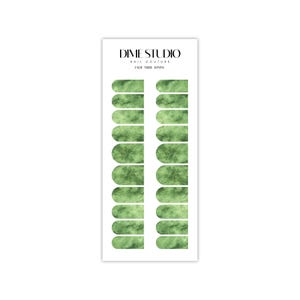 May include: A sheet of green marble-patterned nail wraps for a manicure. The nail wraps are designed for a full-coverage look and are arranged in two rows of ten. The sheet is labeled "DIME STUDIO NAIL COUTURE JADE NUDE 30MM".