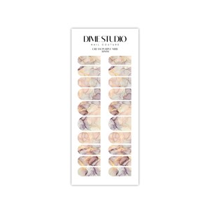 May include: Cream and purple marble nail polish wraps with gold accents. Dime Studio Nail Couture.