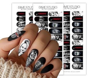 May include: A set of nail decals featuring black and white illustrations of the character Chucky, including the red Chucky logo text. The decals are presented on a white backing sheet labeled Dime Studio Nail Couture, with some designs showing colored eyes.