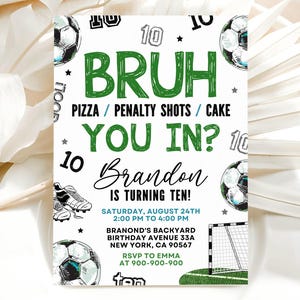 May include: A rectangular birthday invitation card featuring football-themed graphics including footballs, boots, and a goal net. The text reads: BRUH PIZZA / PENALTY SHOTS / CAKE YOU IN? Brandon IS TURNING TEN! SATURDAY, AUGUST 24TH 2:00 PM TO 4:00 PM.