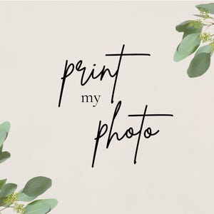 May include: A white background with green leaves on either side and the text "print my photo" in black cursive writing.