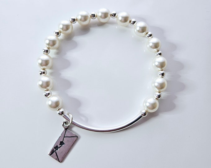 Truly Blessed Love letter bracelet with white pearl beads and sterling silver love letter charm.