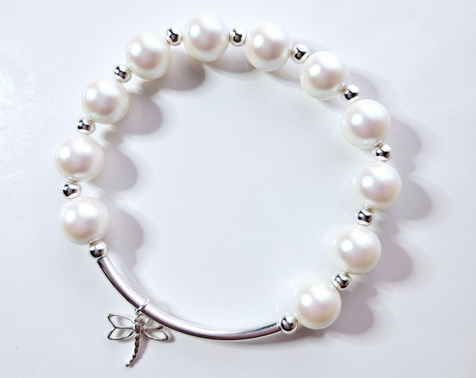 Dragonfly charm bracelet with Austrian crystal white pearls and sterling silver beads.