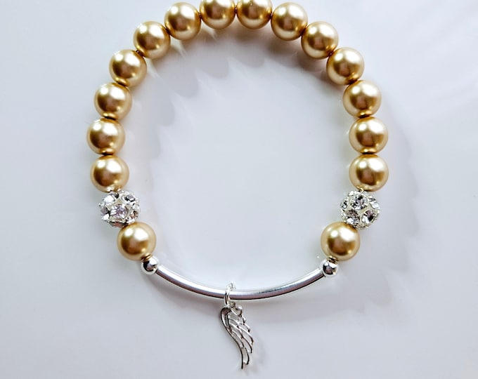 Silver Angel wing charm bracelet with Austrian crystal gold pearls, rhinestone pave beads and sterling silver beads.