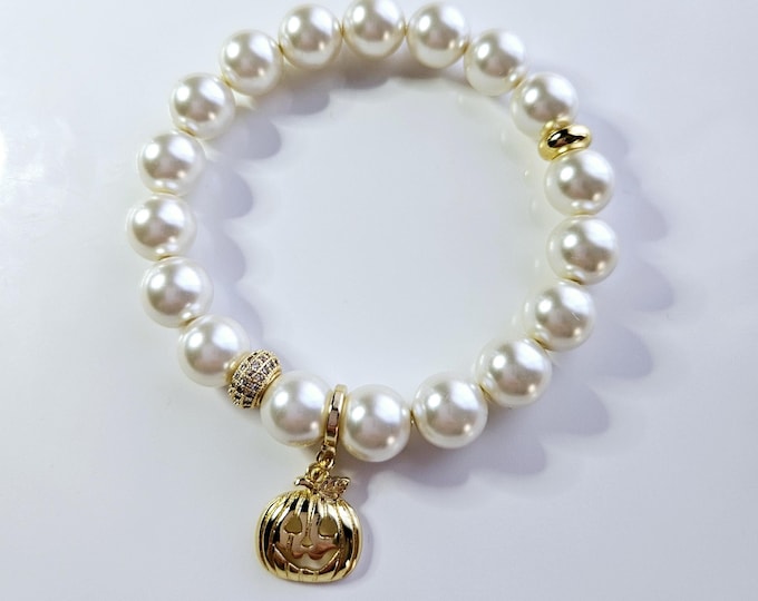 Pumpkin charm bracelet with Austrian crystal white pearls and 18kt gold pumpkin charm.