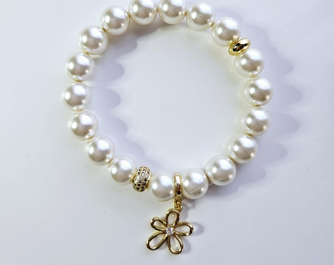 Flower power charm bracelet with Austrian crystal white pearls and 18kt gold crystal flower charm.