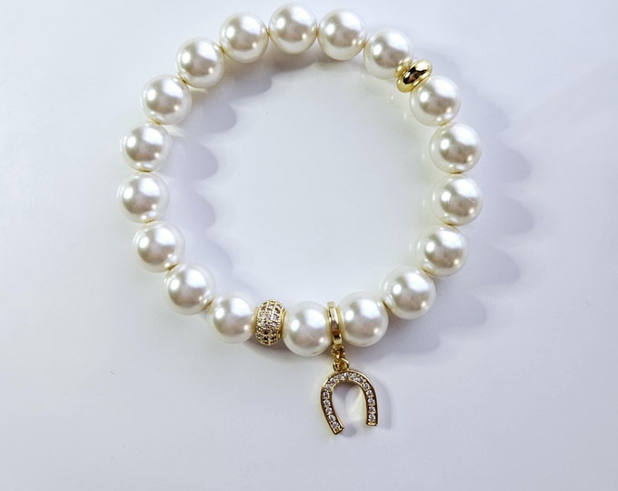 Lucky Horseshoe charm bracelet with Austrian crystal white pearls and 18kt gold rhinestone horseshoe charm.