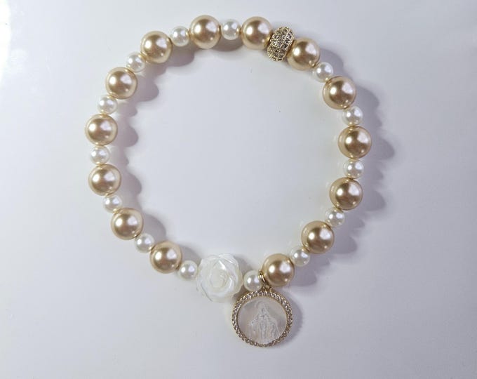 Gold pearl bracelet with mother of pearl flower and gold filled Virgin Mary charm.