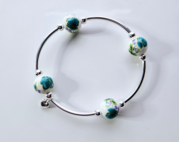 Truly Blessed, count those blessings bracelet with white porcelain beads with hand painted mint green floral design and silver charm.