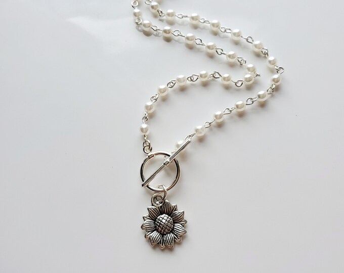 silver sunflower charm necklace on pearl rosary bead chain