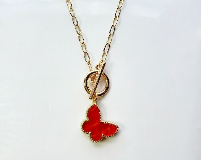 Butterfly charm necklace with red Mother of pearl butterfly charm on gold plated paperclip chain.