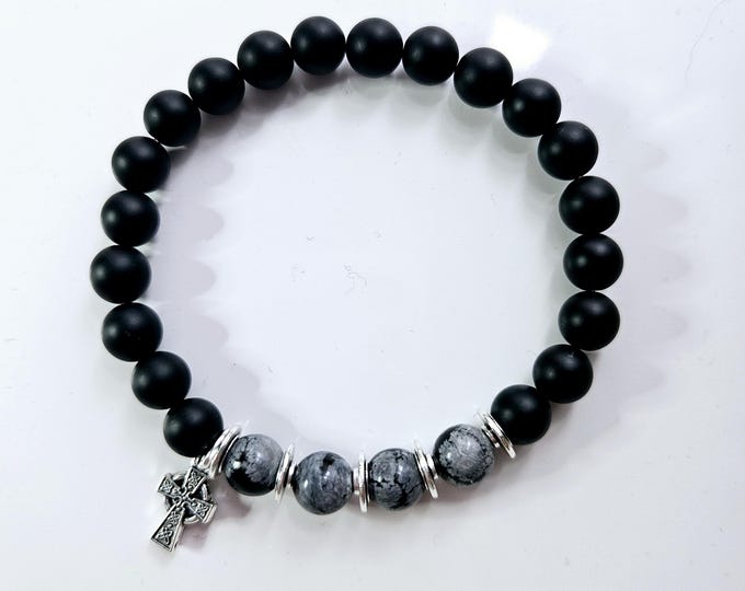 Black onyx and snowflake obsidian bead bracelet with Celtic cross charm.