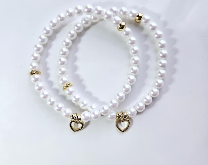 Connected by our hearts bracelets are made with Austrian crystal pearlescent white pearls and 14kt gold filled heart charm.