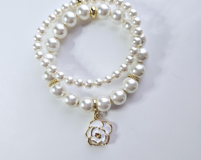 White Austrian crystal flower power pearl bracelet duo with enamel and gold plated flower charm.