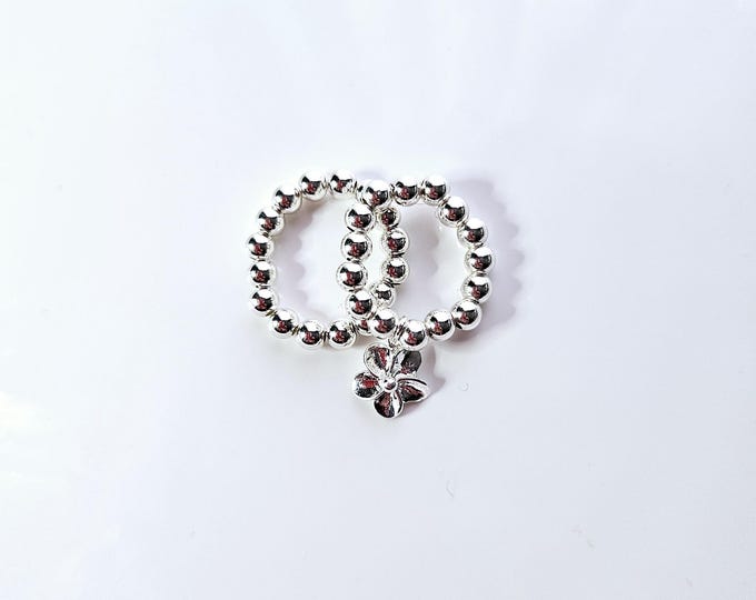 Sterling silver bead stackabke ring with sterling silver Flower charm.