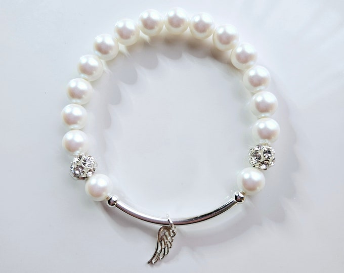 Silver Angel wing charm bracelet with Austrian crystal white pearl beads, rhinestone pave beads and sterling silver beads.