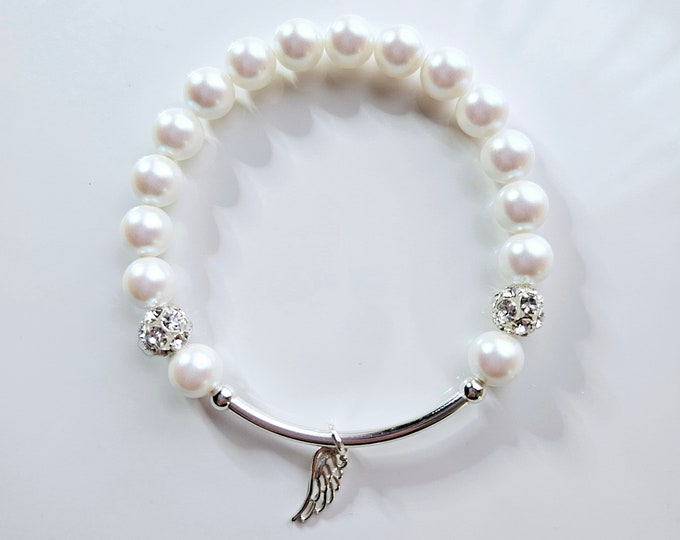 Silver Angel wing charm bracelet with Austrian crystal white pearls, rhinestone pave beads and sterling silver beads.