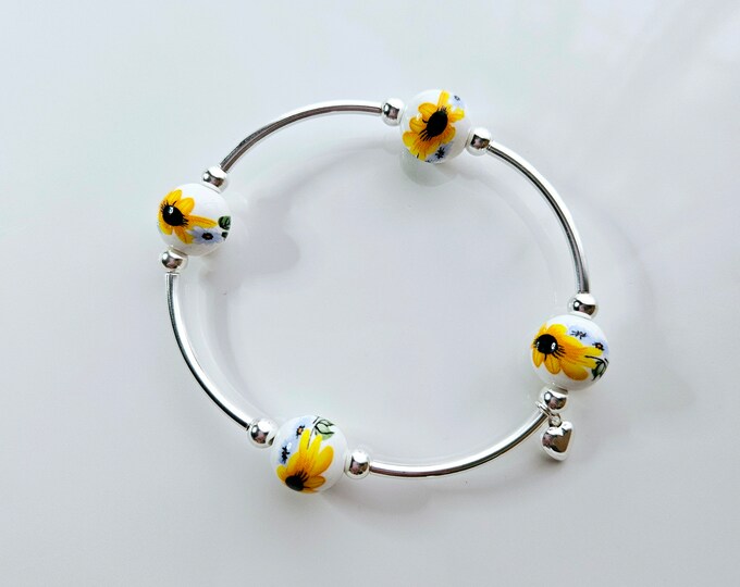 Truly Blessed, count those blessings bracelet with white porcelain beads with hand painted yellow sunflower design and silver heart charm.