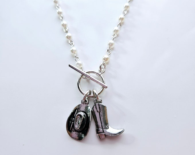 Cowboy boot and hat charm necklace on pearl rosary bead chain.